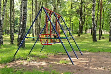 Baby swings in green birch city park