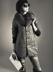 Young fashion woman in coat studio shot , black and white photo