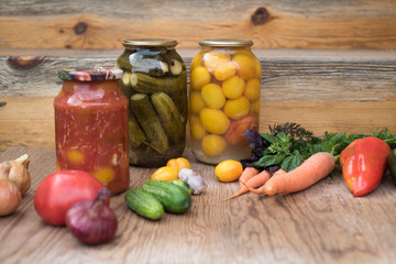 Fototapeta na wymiar Fresh and pickled vegetables on wooden background 