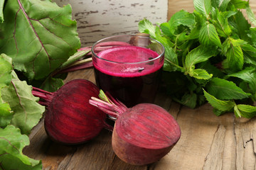 Fresh beet juice on wooden table, closeup