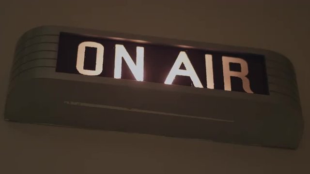 A lit up on-air sign

