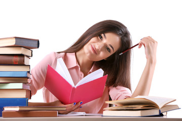 Young girl reading book isolated on white
