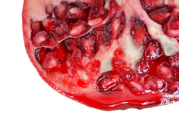 Pomegranate cut consumed with juice flowing down isolated on a white background