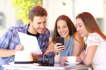 Tourist friends planning vacation with gps phone