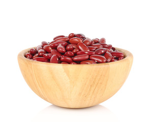 Haricot beans in brown wooden bowl isolated on white background