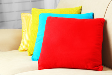 Colorful pillows on sofa, close-up