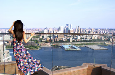 Beauty looking at Brooklyn at New York City rooftop in the summer