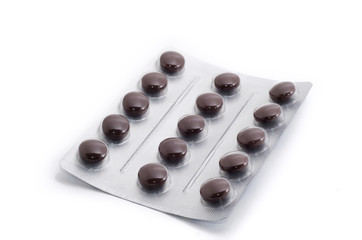 Brown pills in aluminium blister isolated