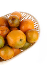 orange fruit in basket, isolated on white background