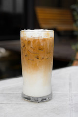 Iced coffee with milk is on the table.