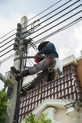 an electrical lineman working on a line