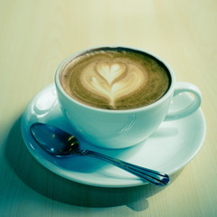 Hot art Latte Coffee in a cup on wooden table