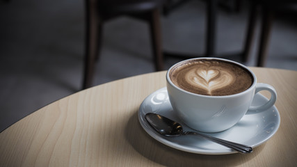 Hot art Latte Coffee in a cup on wooden table