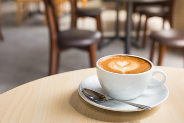 Hot art Latte Coffee in a cup on wooden table