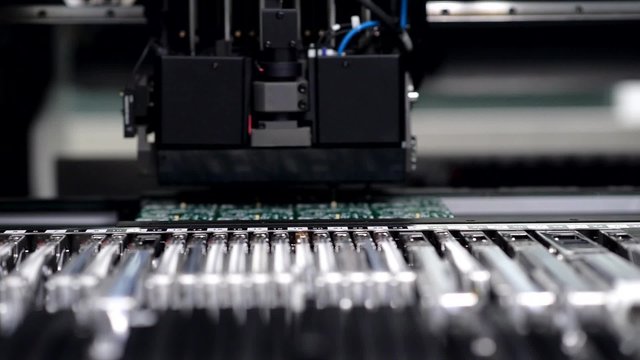 Close-up of automated electronics parts manufacturing