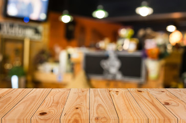 Selected focus empty brown wooden table and Coffee shop blur bac