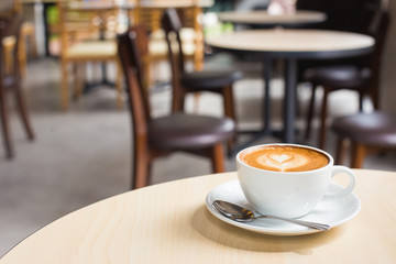 Hot art Latte Coffee in a cup on wooden table