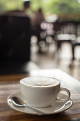 Hot art Latte Coffee in a cup on wooden table