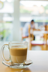 hot latte coffee on wooden table, vintage and retro style