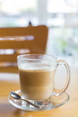 hot latte coffee on wooden table, vintage and retro style