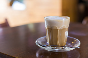 hot latte coffee on wooden table, vintage and retro style