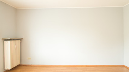 Empty room with gray wall and parquet floor