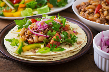 Mexican tacos with meat, beans and salsa