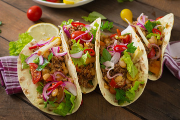 Mexican tacos with meat, beans and salsa