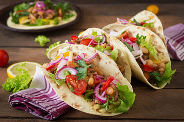 Mexican tacos with meat, beans and salsa