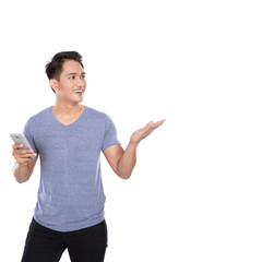 Asian young man holding a hanphone, presenting hand gesture