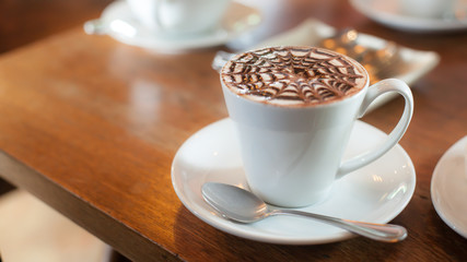 A cup of coffee with decorate milk foam