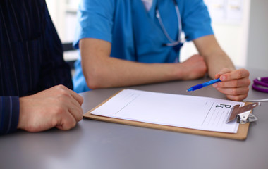 close up of patient and doctor taking notes