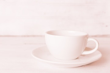 Coffee cup on wooden board with vintage filter effect