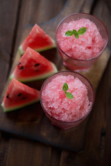 Watermelon granitas and watermelon slices, high angle view
