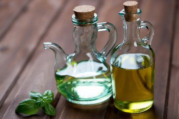 Close-up of two glass bottles with olive oil, selective focus