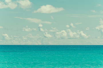 blue sky and water of ocean - vintage film filter