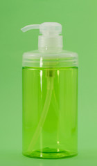 Pump bottle isolated on green background