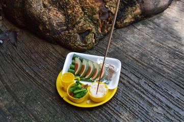 food in plastic tray for sacrifice to the wandering spirit