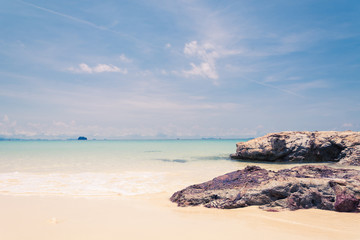 blue sky with sea and rock - soft focus with film filter