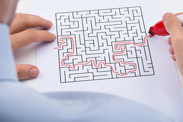 Person Solving Maze Puzzle