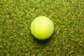 tennis ball on tennis grass court