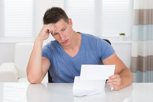Stressed Man Looking At Paper