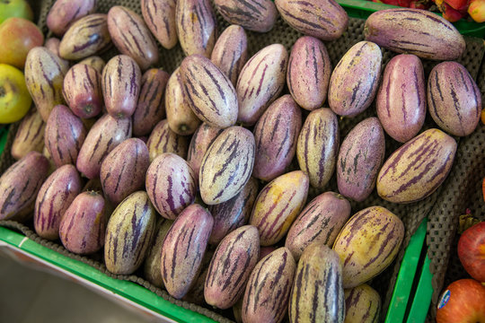 Tamarillos in green tray in a market stall