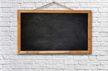 Empty black board on white brick wall texture background