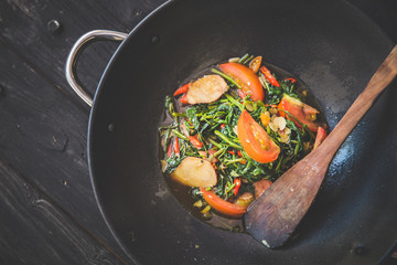 stir-frying kale with tomato, close up
