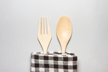 wooden spoon and fork with brown table striped Fabric