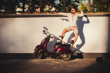 young man in sunglasses on scooter