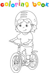 Young boy riding a bicycle in helmet