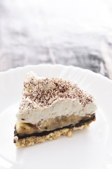 Banoffee wipe cream cake in soft light and selective focus
