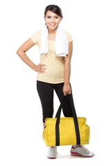 Happy fit young woman with gym bag standing ready for fitness ex